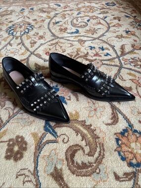ALEXANDER MCQUEEN Black leather pointed toe loafers. Size 6.5 US. Made in Italy.